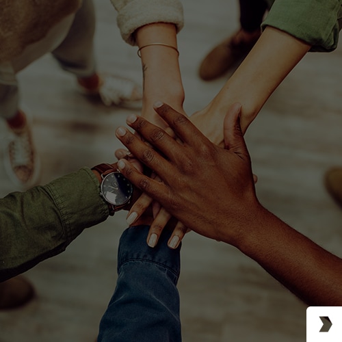 a group of people  holding hands, creating a sense of unity and connection